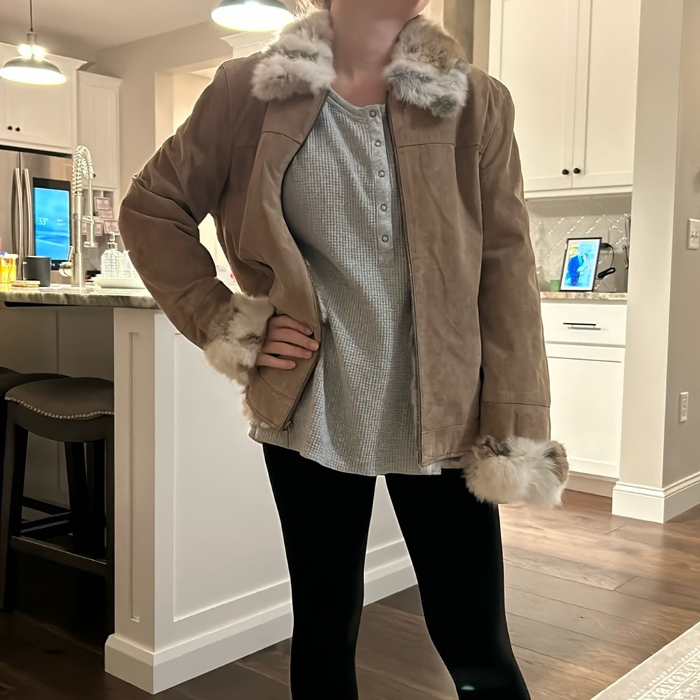 Leather coat with fur around collar, sleeves.